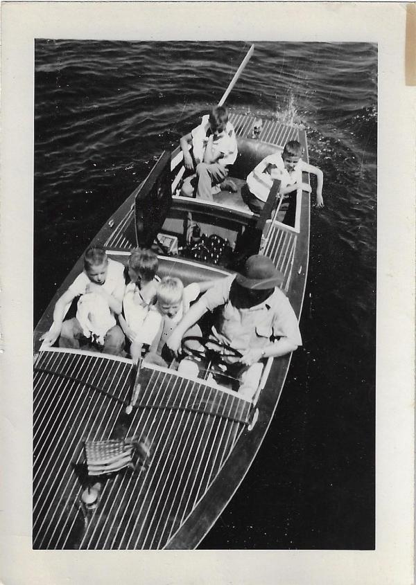 historic photo of a group of boys on an old motorboat