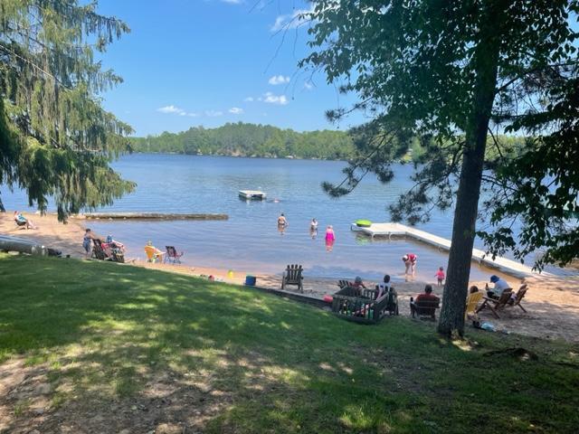 a family playing at the resort beach on a sunny summer day